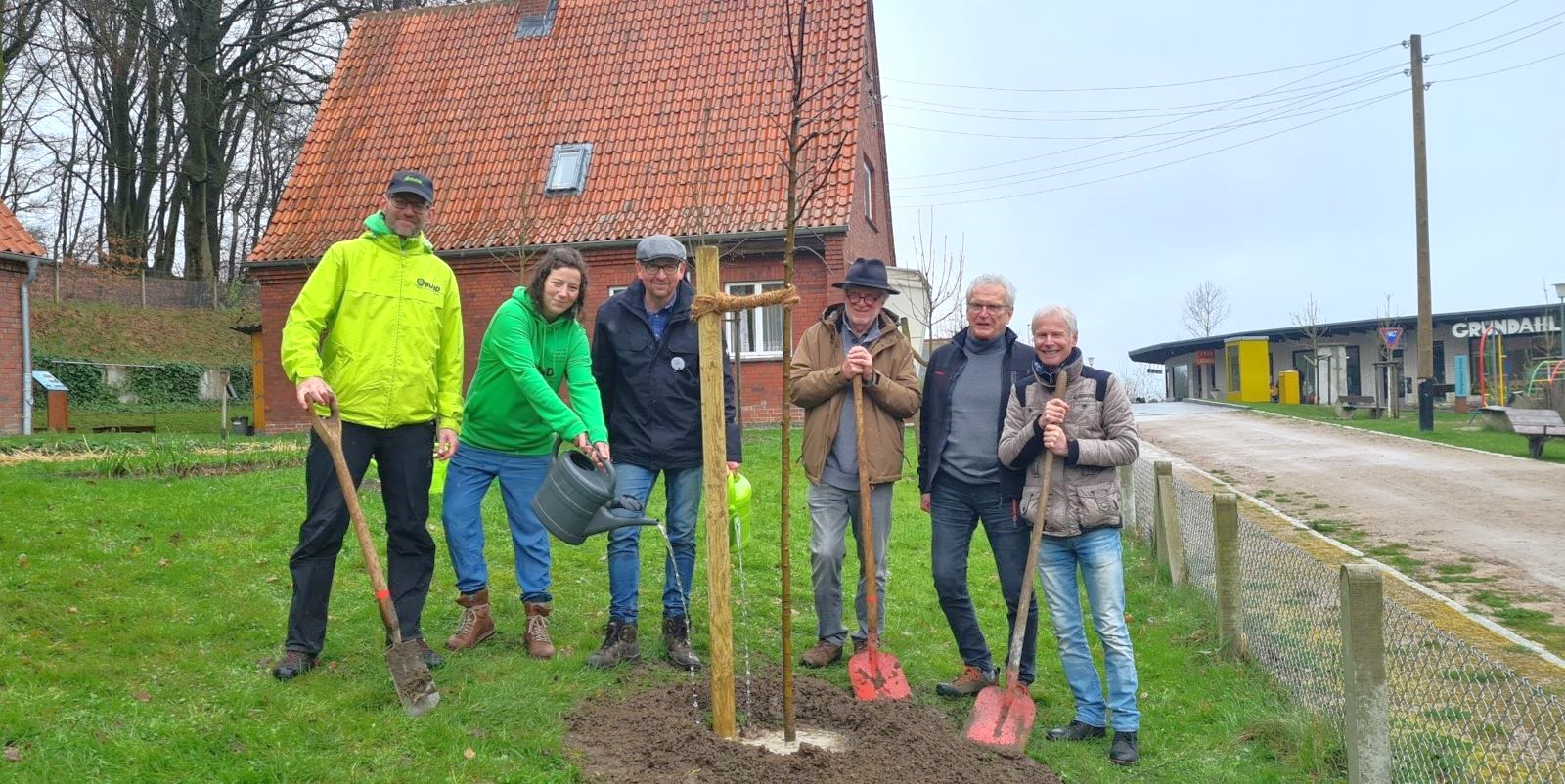 Bernhard Vogt (v.l., BUND Hamburg), Nora Kolter (BUND Hamburg), Matthias Schuh (Gärtner), Joachim Reinig (Pomologenverein) Ulrich Kubina (Projektleiter Norddeutsche Apfeltage) und Thomas Schönberger (UmweltHaus im Rockenhof) pflanzen den Apfel des Jahres. Foto: FLMK