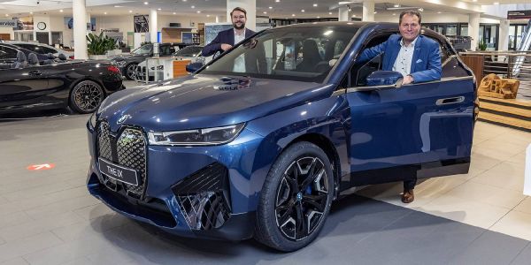 Filialleiter DAvid Breuer (vorn) und sein Verkaufsleiter Helge Rath mit dem neuen iX von BMW. Foto: André Zand-Vakili Premiere bei B&K: Der neue iX von BMW zog viele Blicke auf sich